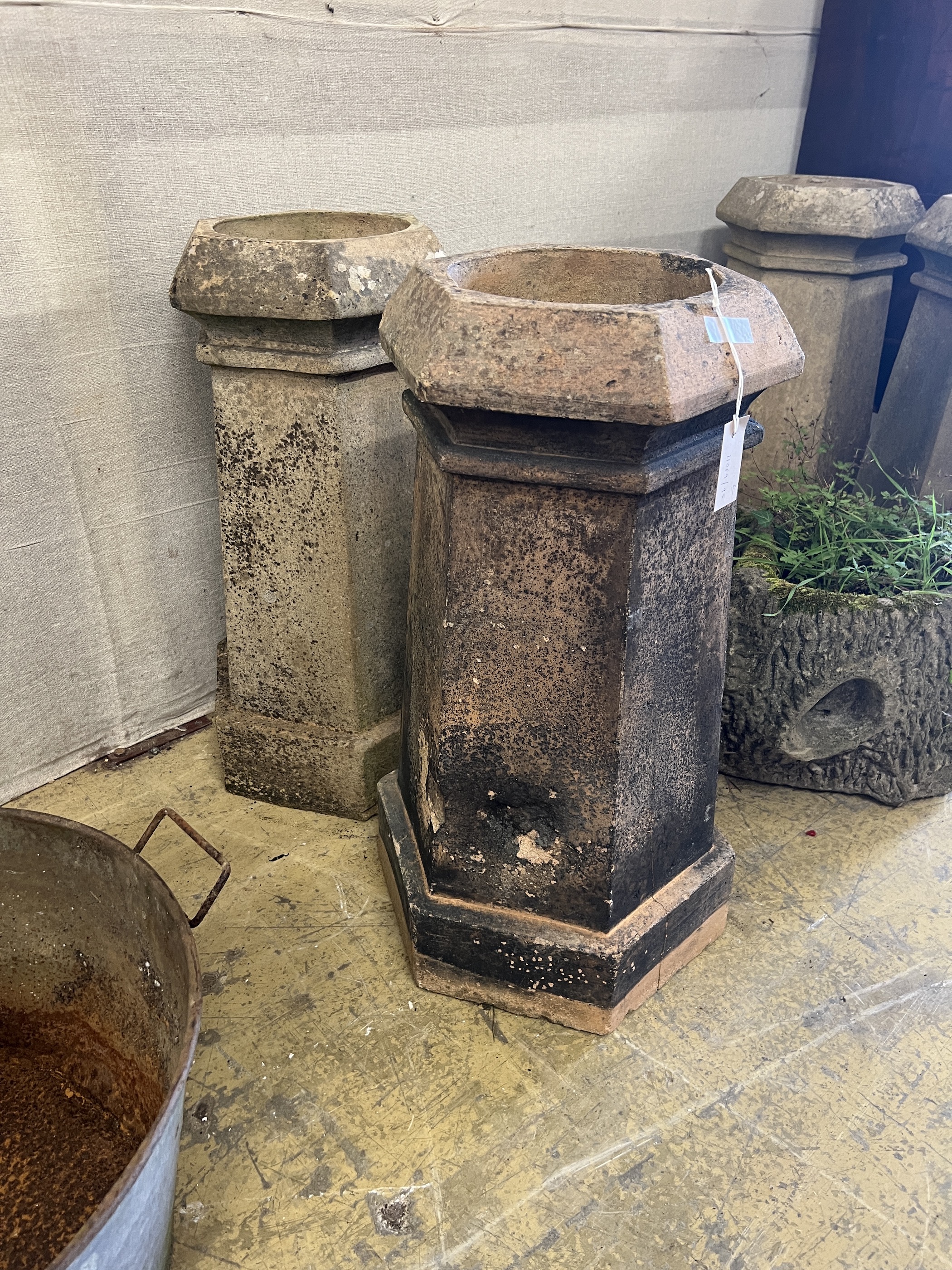 A pair of hexagonal terracotta chimney pots, larger height 71cm